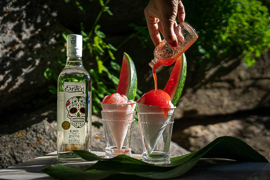 Two cups of watermelon tequila snowcone with a bottle of Exotico® Blanco